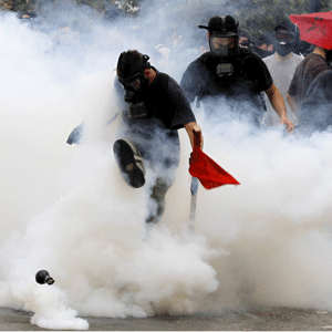 Demonstrator kicks away tear gas canister outside the Parliament in central Athens, during a rally against plans for new austerity measures, Wednesday, June 15, 2011. A 24-hour strike by Greece"s largest labor unions is set to cripple public services Wednesday, as the Socialist government begins a legislative battle to push through last-ditch cost cutting reforms that will exceed its own term in office. Demonstrators had camped outside the parliament since May 25, 2011. 