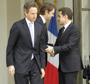 French president, Nicolas Sarkozy (right), yesterday hailed French Finance Minister Francois Baroin (middle), after the meeting with American Treasury Secretary Timothy Geithner (left), at the Elysee Palace. Geithner said yesterday that he is very impressed with Europe's progress to come up with a plan to solve the Eurozone's debt crisis problem.